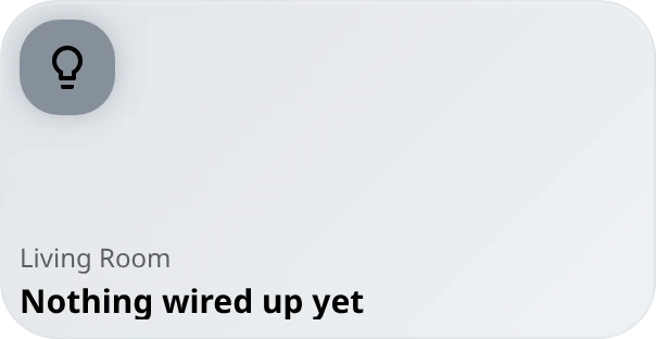 A dark glass tile with a dim outlined bulb icon, titled Living Room, with the status text: nothing wired up yet.